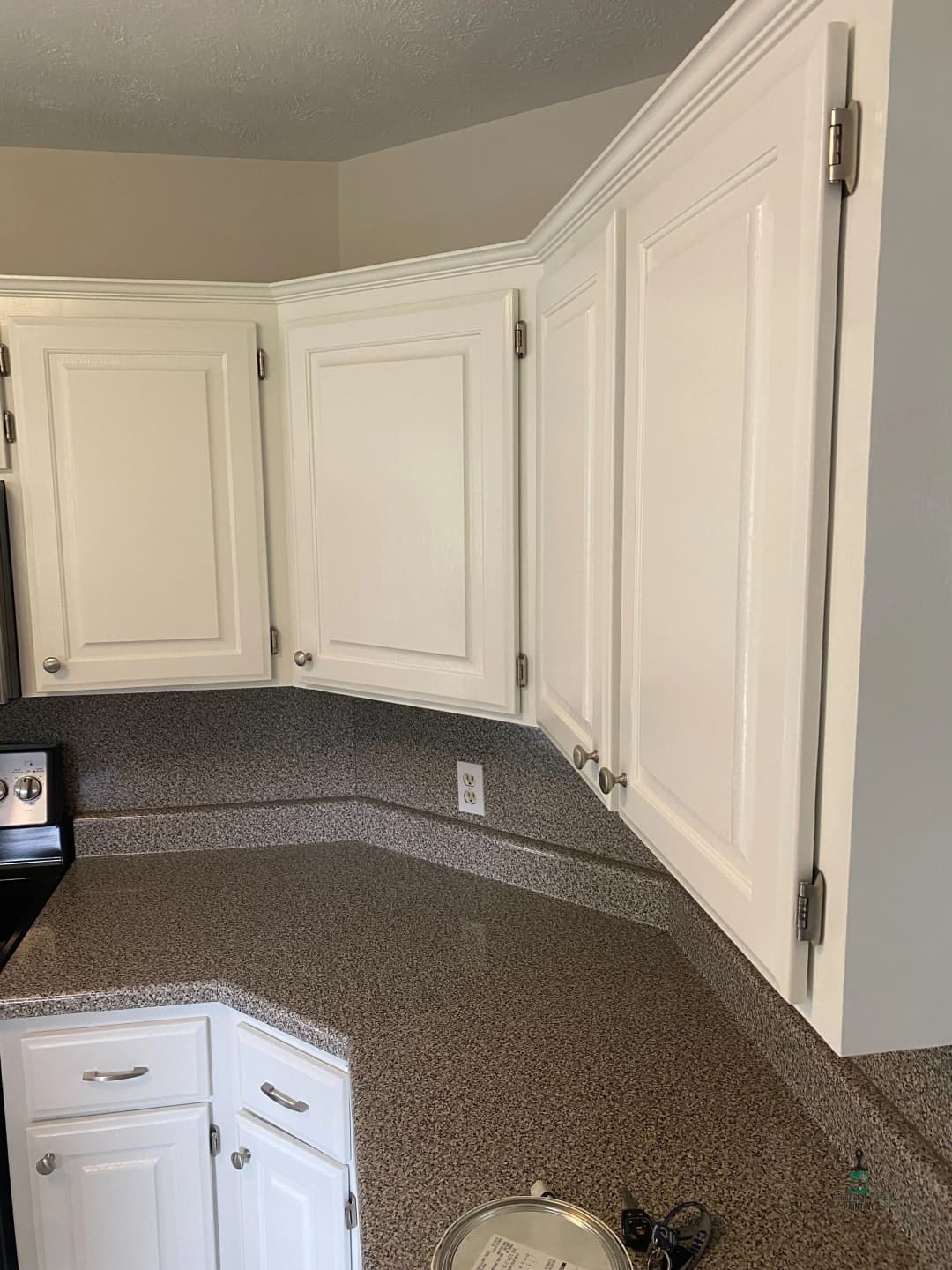Modern kitchen with white cabinets and granite countertops, highlighting a clean design.