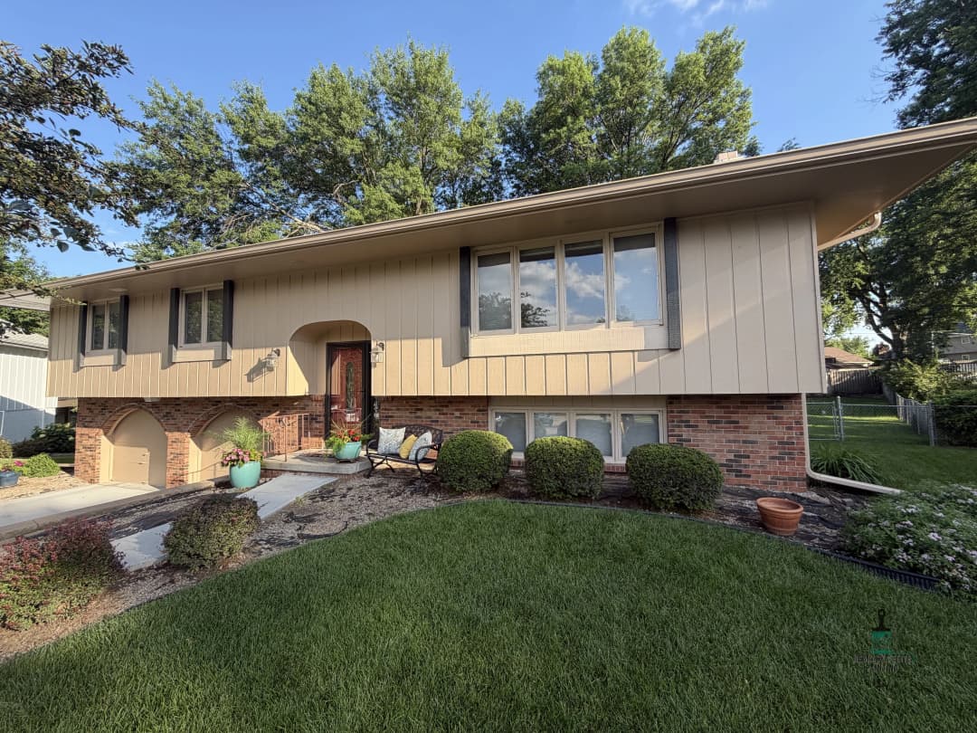 Modern split-level home with landscaped front yard and bright windows, surrounded by greenery.