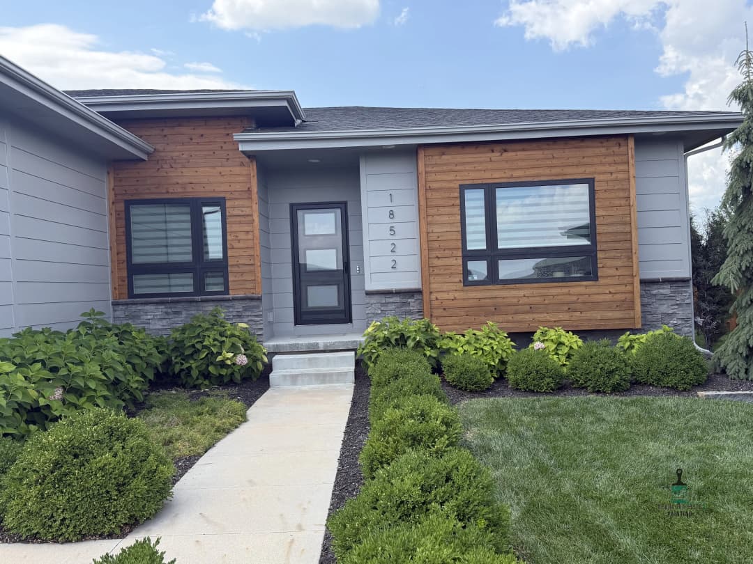Modern home exterior with mixed materials, landscaped yard, and address 18522.