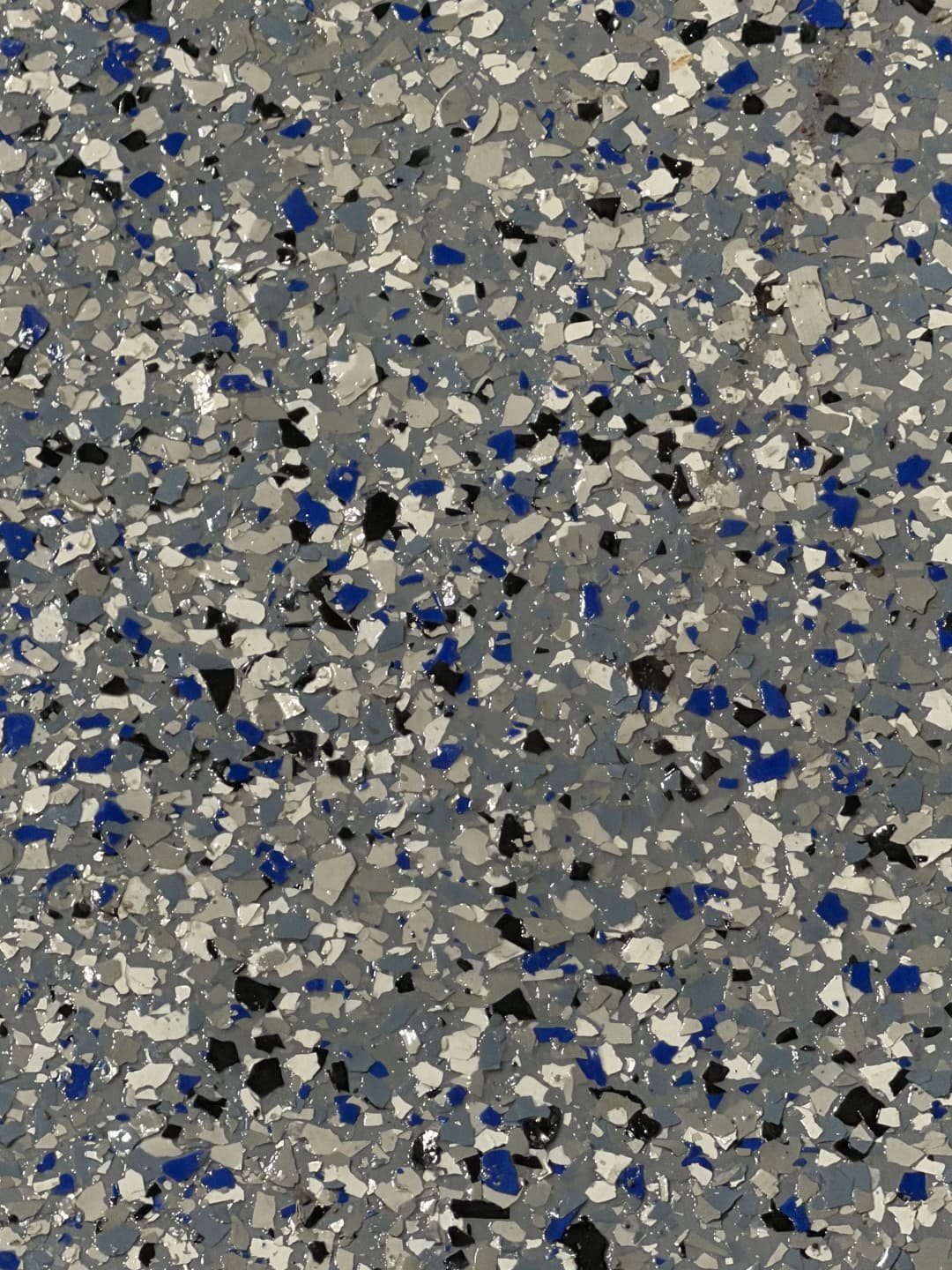 Gray and blue speckled flooring with a textured, mosaic-like design.