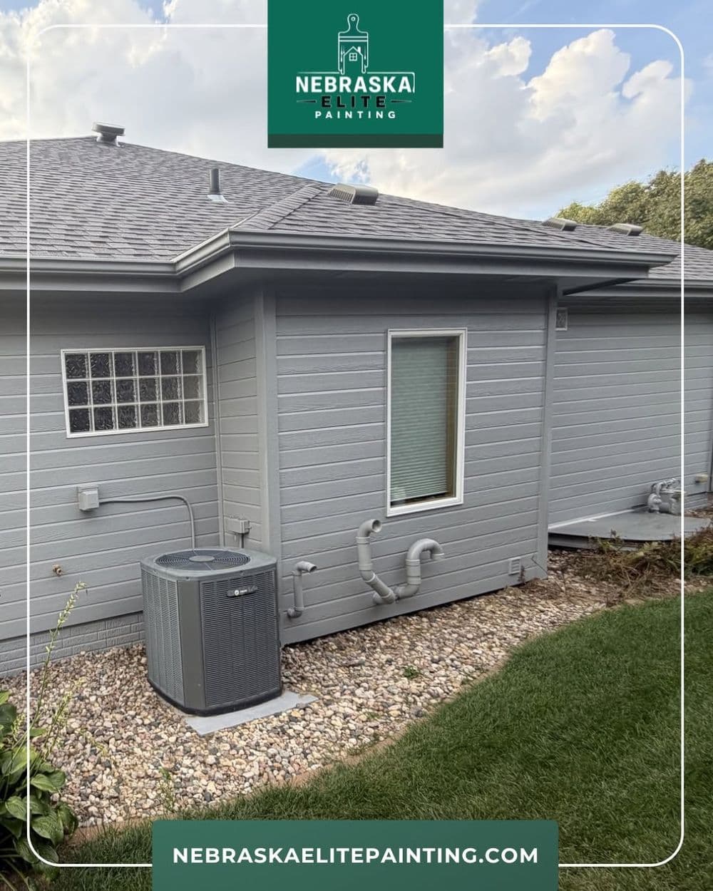 Nebraska Elite Painting services exterior home painting with modern gray siding and landscaping.