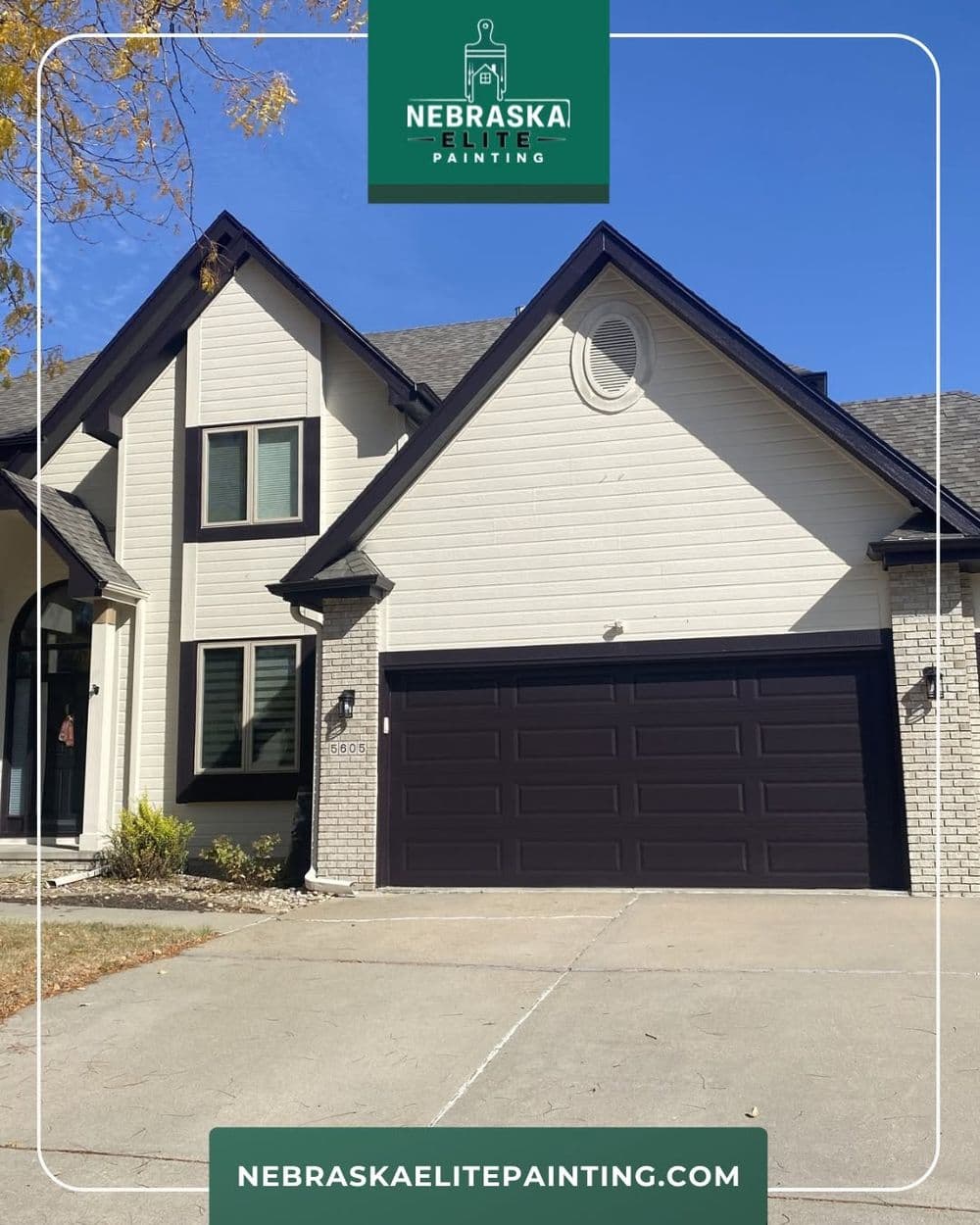 Exterior of a modern home with new paint, featuring black garage doors and a stylish facade.