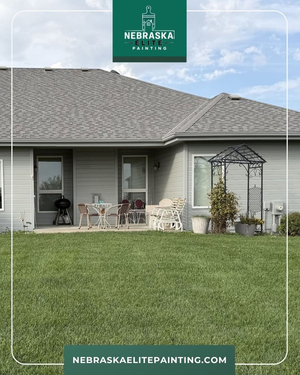 Modern home exterior with landscaped lawn, seating area, and decorative archway. Nebraska Elite Painting.