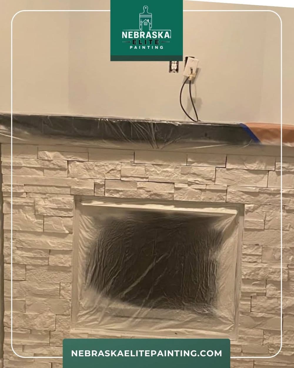Interior painting project showing a partially painted stone fireplace with protective covering.