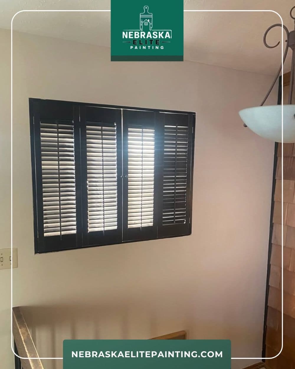 Black wooden blinds on a window in a modern interior setting.