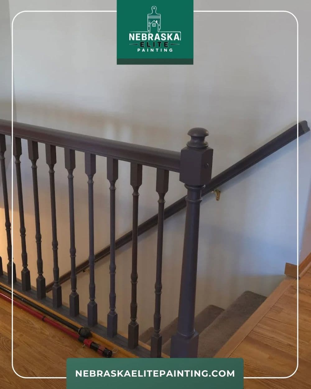 Modern staircase railing painted in dark gray, featuring wooden stairs. Nebraska Elite Painting.